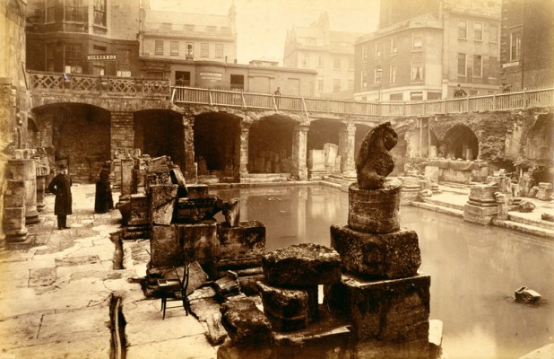 England, Roman Baths, Bath (1)
These celebrated Roman Baths were unknown until, in 1880, sewer workers uncovered the first glimpse of Roman structures under the Georgian Spa. This led to the discovery of the Roman Baths and their treasures.
 
The walls, columns and parapet that surround the Great Bath today were built in the Victorian period, and the "Roman" statues that gaze down upon the pool from the upper walkway are also Victorian. 

This photograph was taken in the 19th century not long after the Baths were discovered and before the Victorian structures we see today were built.

