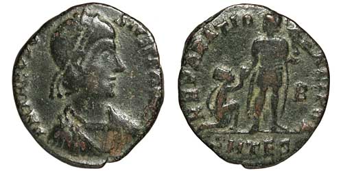 A billon coin of Theodosius I showing the emperor raising a kneeling woman.